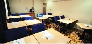 Boardroom at Holiday Inn Express Limehouse, featuring blue chairs for professional meetings.